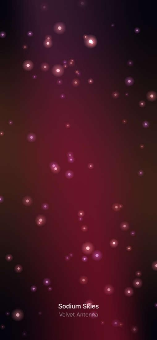 Immersive full-screen music visualiser with artwork-tinted glowing particles